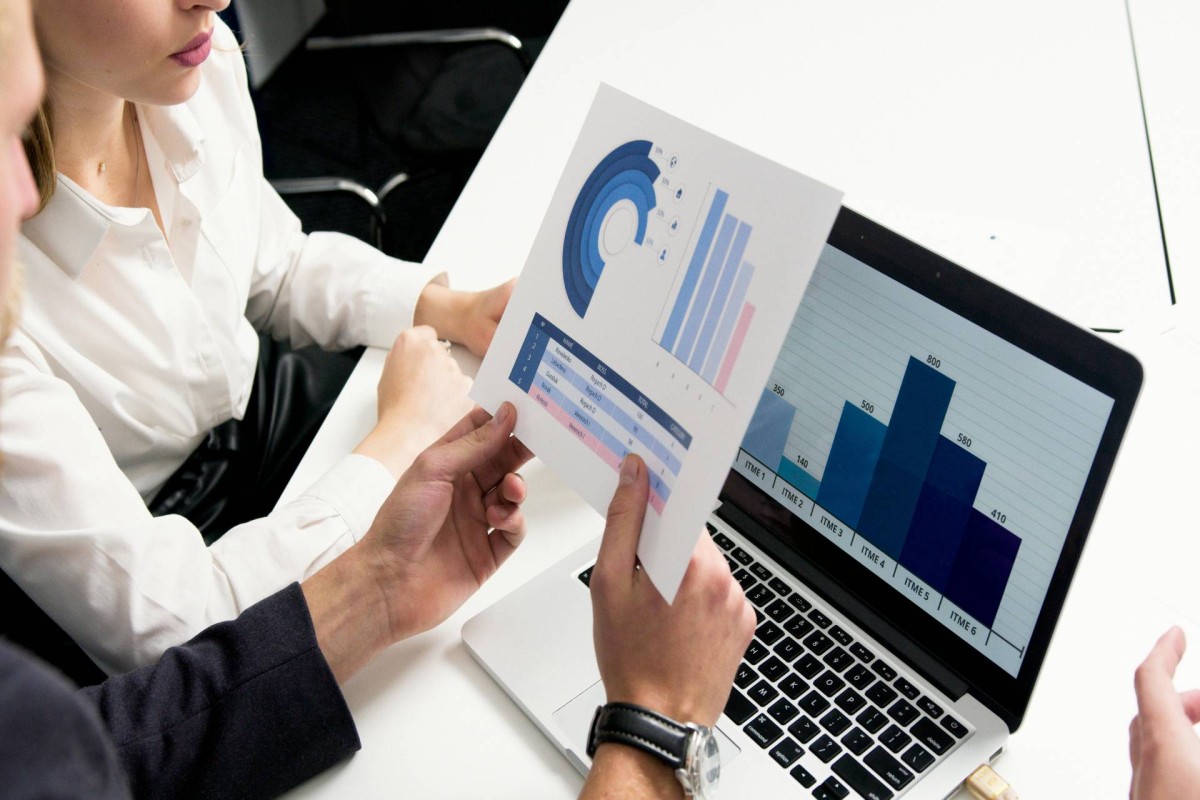 People discussing financial charts and graphs during a meeting