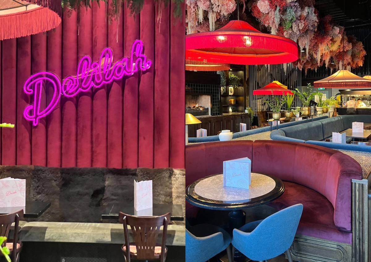 Interior of Delilah restaurant with pink neon sign and stylish seating area