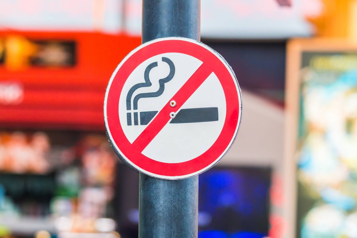 A round no smoking sign with a red border and a crossed-out cigarette symbol