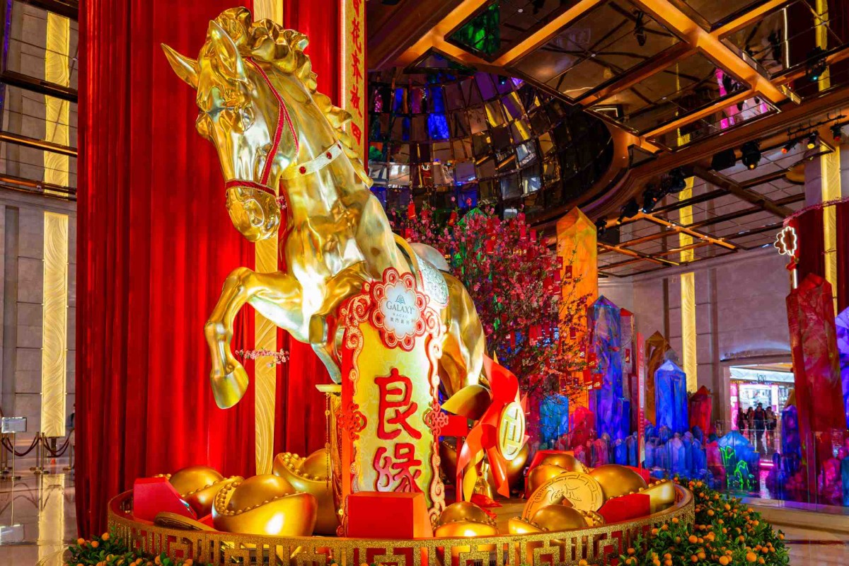 Golden horse sculpture with red decorations for Chinese New Year celebration.