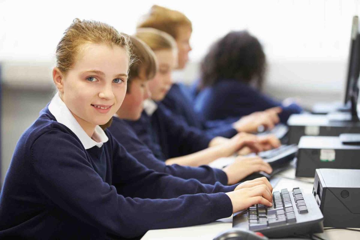 School students using desktop computers in a classroom