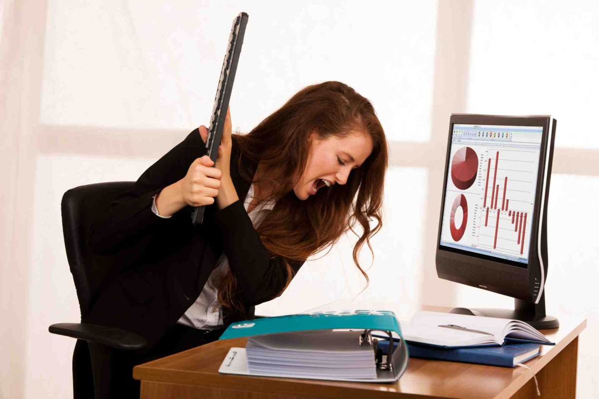 Woman showing frustration while working at a computer
