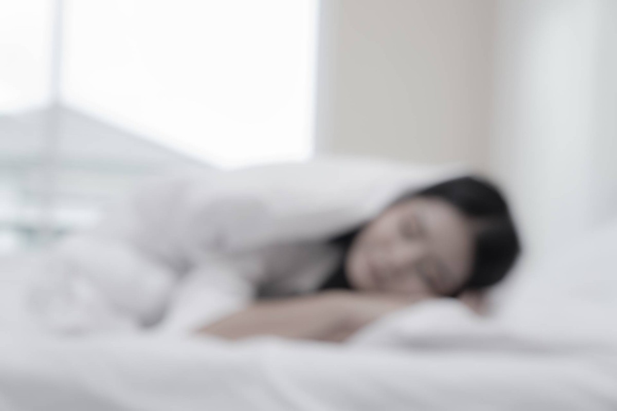 Person sleeping in bed during a short nap