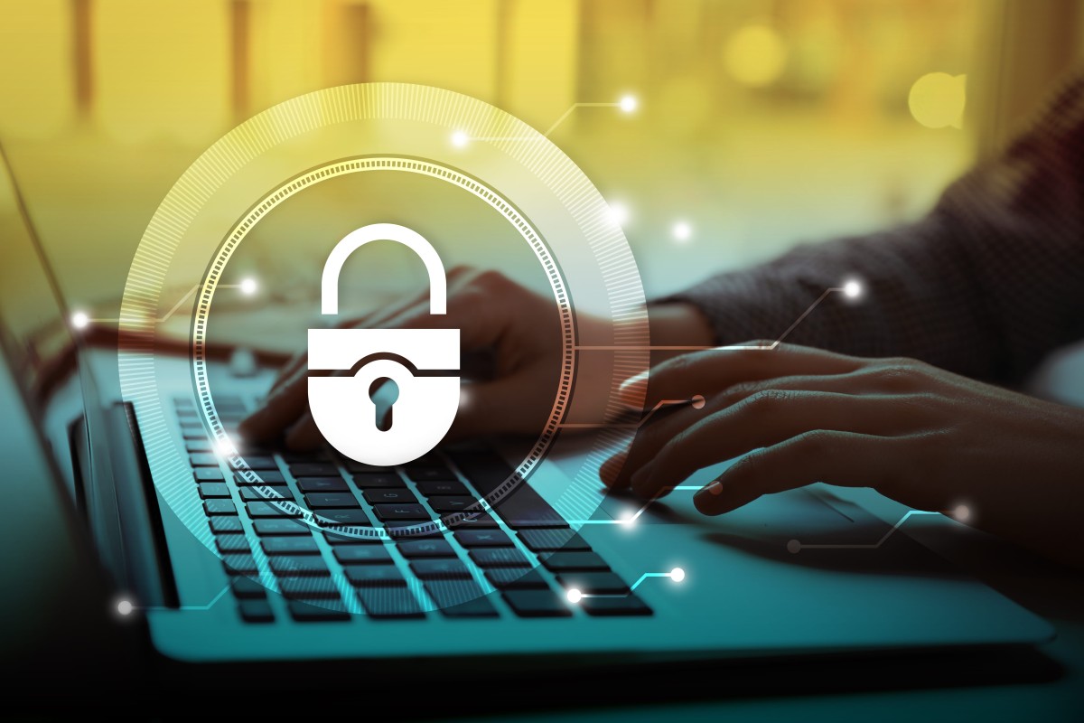 Cybersecurity protection for small businesses with padlock icon over laptop keyboard