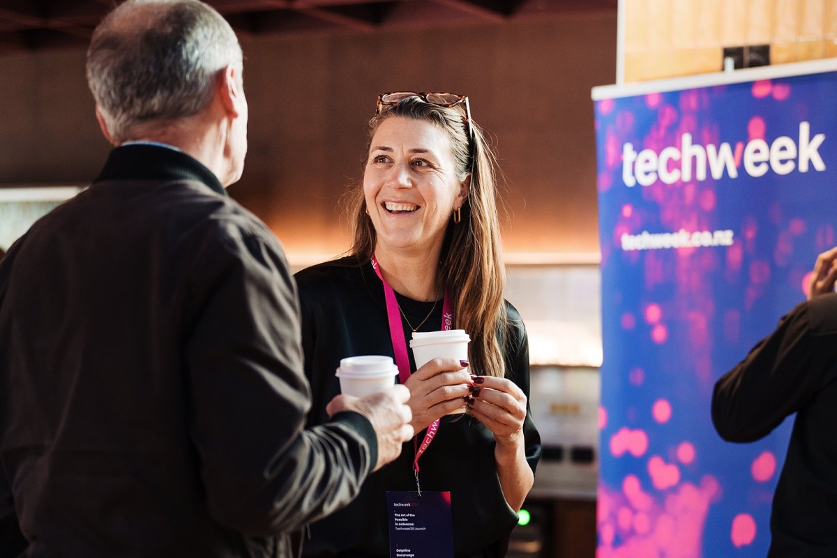 Delphine Ducaruge speaks with an attendee over coffee at a Techweek26 event