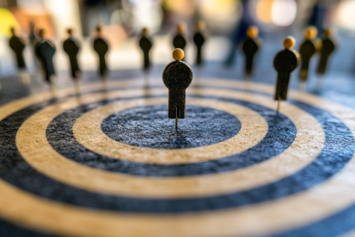 Figure standing in the centre of a target surrounded by other figures, representing recruitment or employee selection
