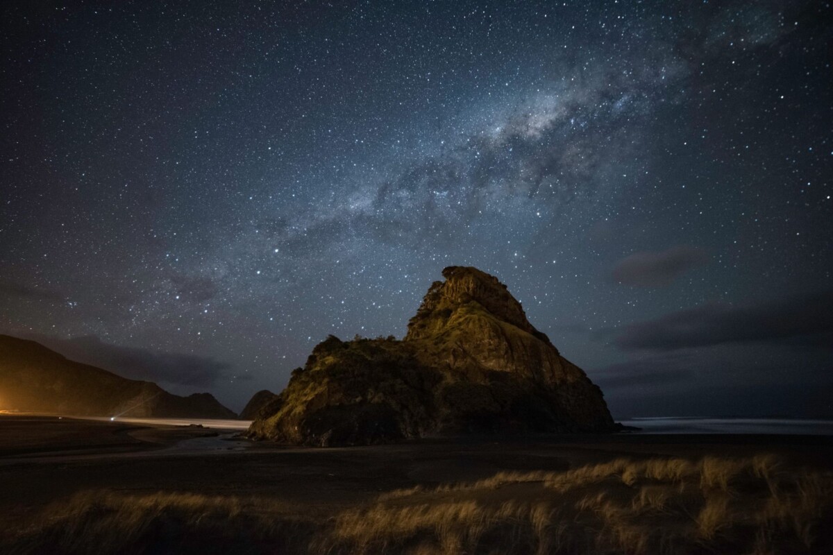 Night view of a rocky coastal landscape at Kaitorete beneath a star-filled sky.